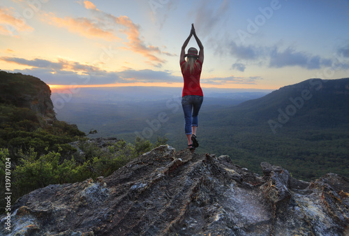 Fotografija Female fitness stretch to the sky mountain top valley scene
