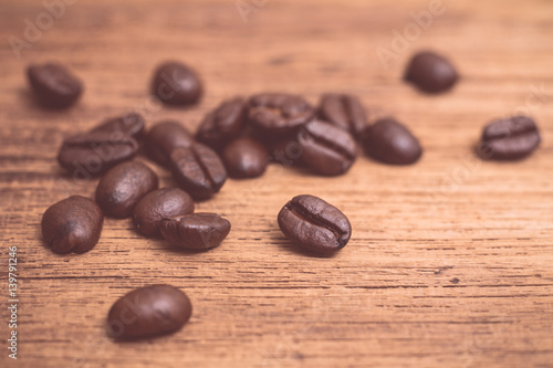 Roasted coffee beans on wood texture background
