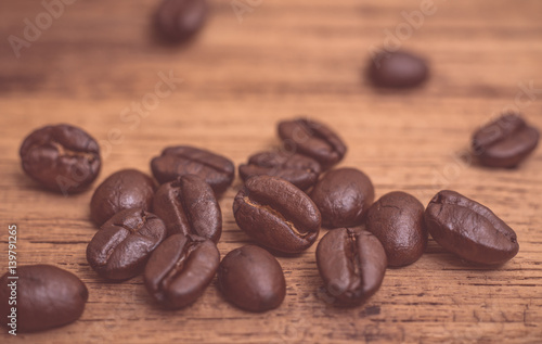 Fototapeta Naklejka Na Ścianę i Meble -  Roasted coffee beans on wood texture background