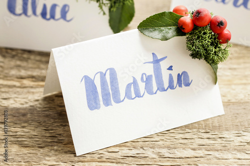 How to make wedding place name cards with handwritten letters and fresh plants. photo