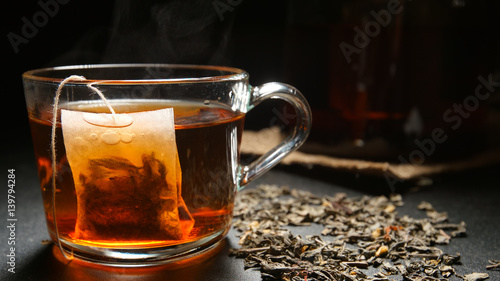 Tea bag in a hot tea cup on a table