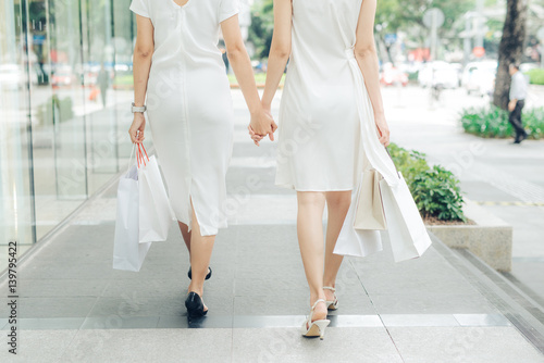 Beautiful asian girls with shopping bags walking on street at the mall © makistock