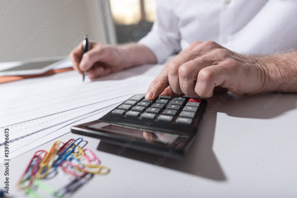 Hand using calculator, accounting concept Hand using calculator, accounting concept