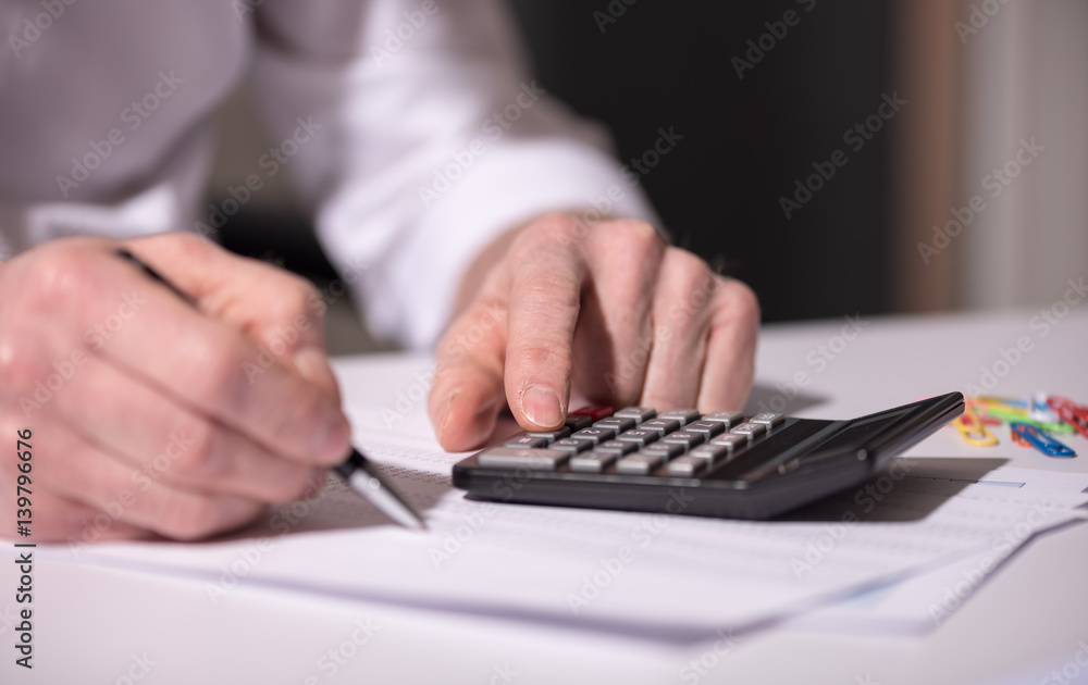 Hand using calculator, accounting concept Hand using calculator, accounting concept