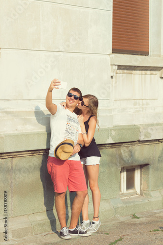 Couple in love using cellphone outdoors.