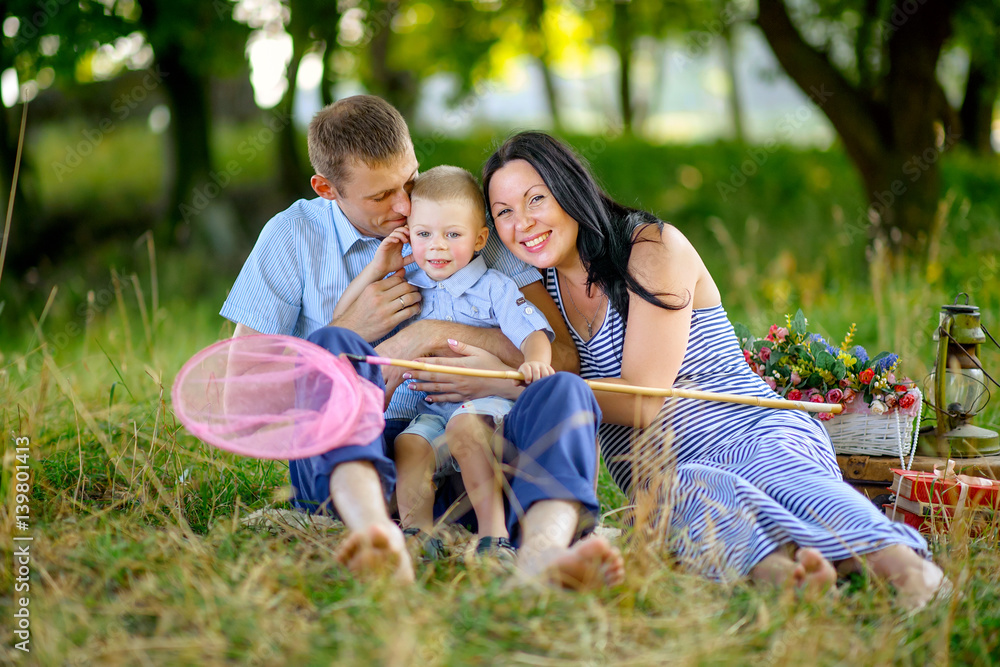 happy family in the evening park on a sunset, play and have fun, bright evening light happy family in the evening park on a sunset, play and have fun, bright evening light