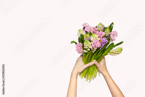 A bouquet of hyacinths in hands. Spring background