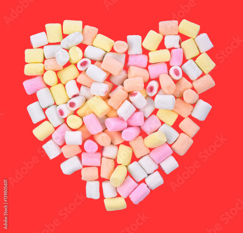 Marshmallows isolated on red background