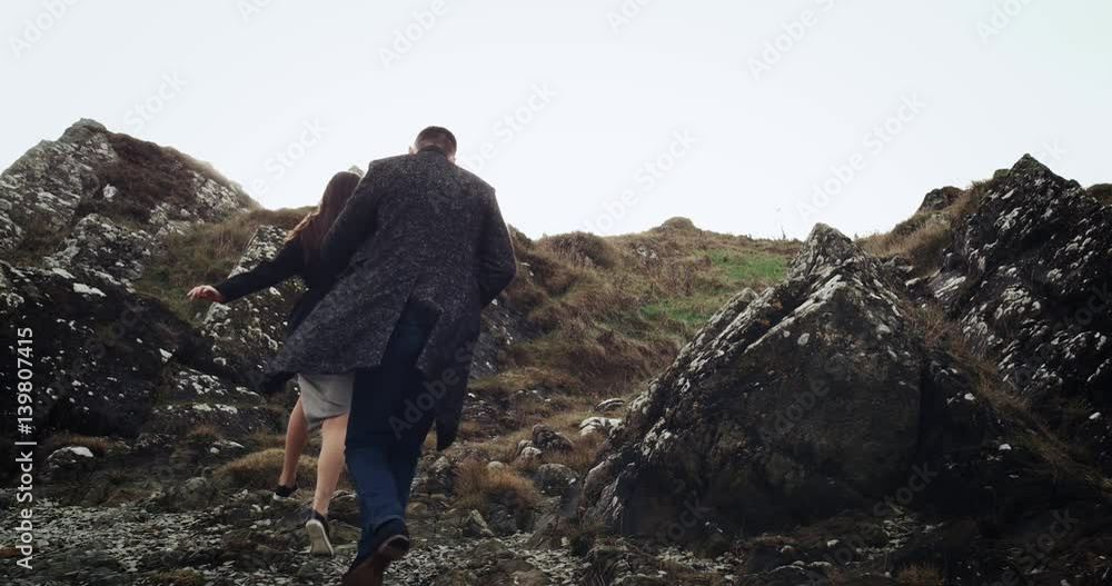 Young Beautiful Brunette Woman Leading By Hand Her Lover On Mountain Road, Follow Me Concept. 4k Young Beautiful Brunette Woman Leading By Hand Her Lover On Mountain Road, Follow Me Concept. 4k