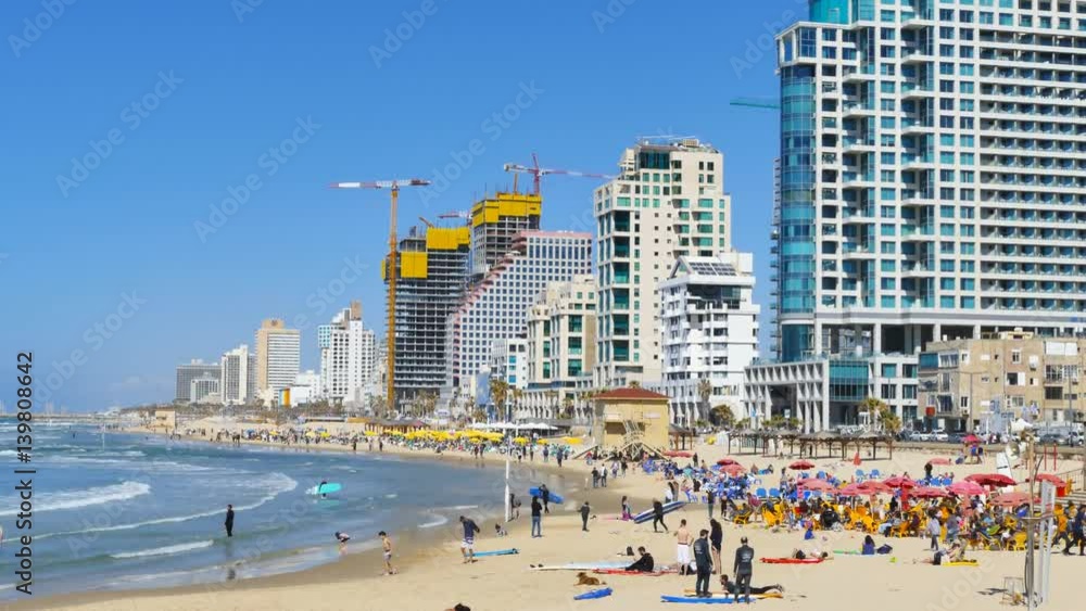 Time lapse - Tel Aviv beach on a summer's day with surfers and people enjoying the sun Time lapse - Tel Aviv beach on a summer's day with surfers and people enjoying the sun