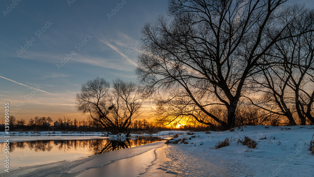 scenic sunset over the river. beautiful winter evening landscape