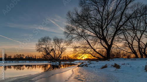 scenic sunset over the river. beautiful winter evening landscape