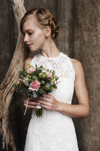 Blond and beautiful bride with bouquet