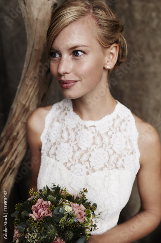 Blue eyed blond bride with bouquet