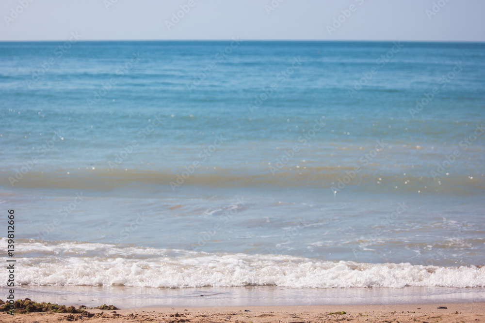 Foam on seashore. Blue sea and sky. Best spot for summer vacation. Sunbathe and swim.