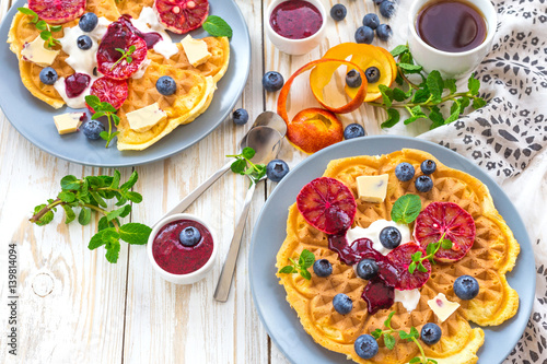 Coffee and Belgium waffles with blueberry. Breakfast concept. © dzevoniia