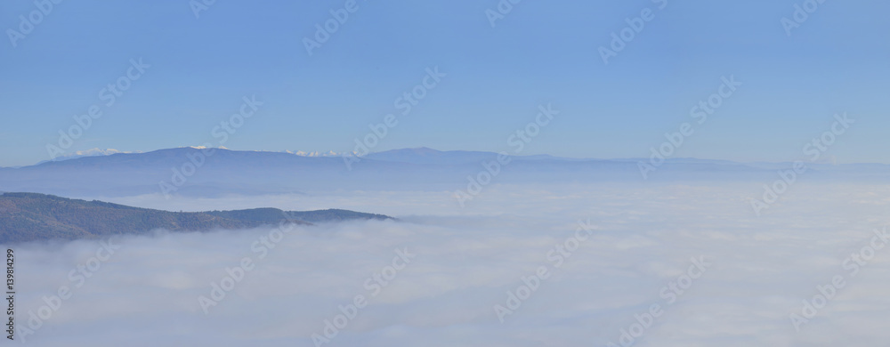 Panorama of fog and cloud mountain valley landscape. misty forest in the morning