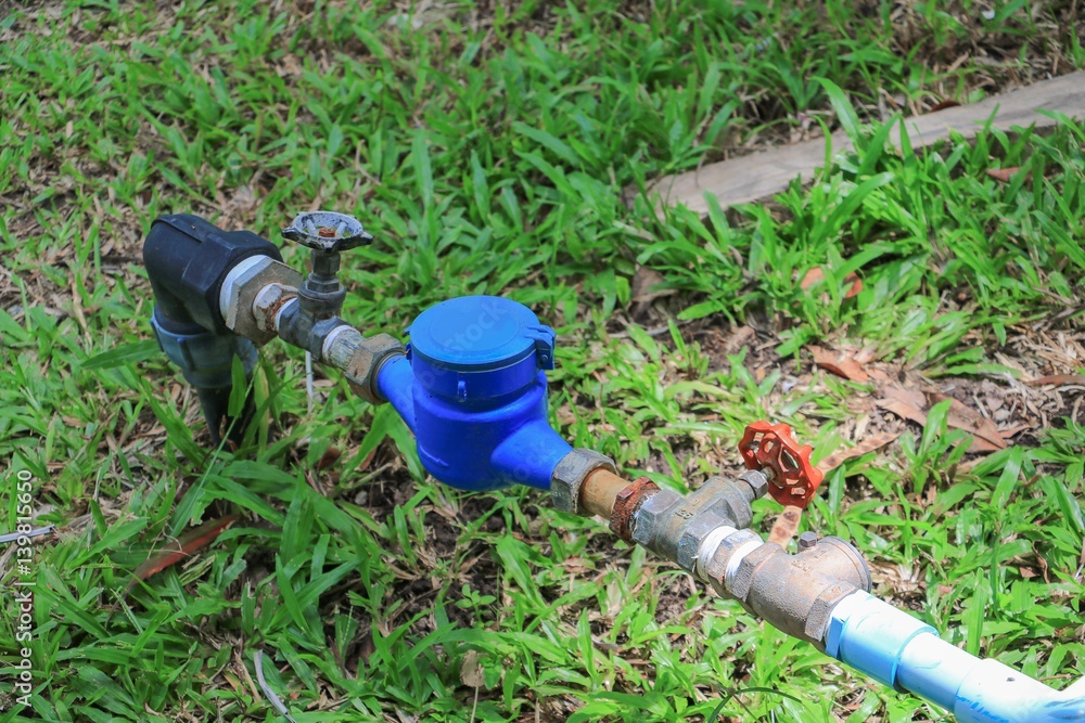 water valve and tap pipe on floor grass, with copy space for add text water valve and tap pipe on floor grass, with copy space for add text