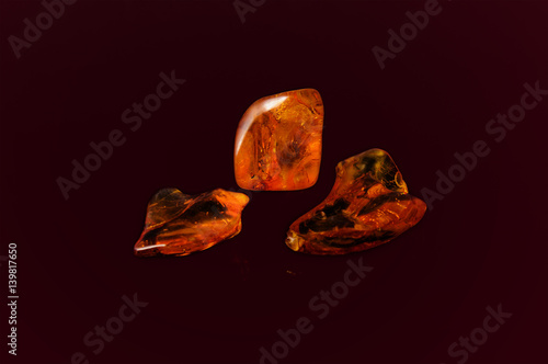 amber gemstone on dark background. Soft focus, photo toned