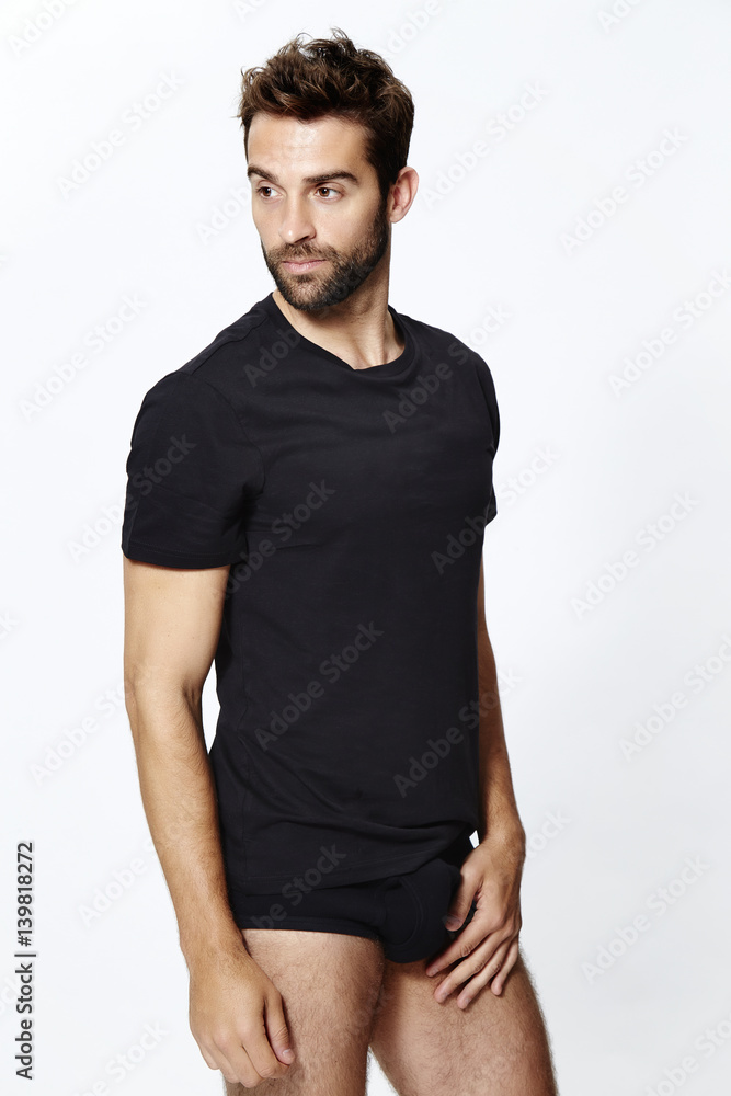 Man in underpants and t-shirt, looking away Man in underpants and t-shirt, looking away