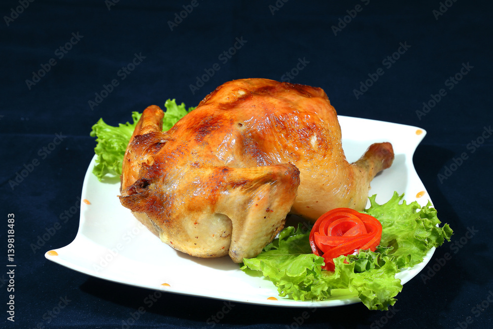 Baked chicken on white plate.