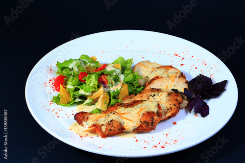 Baked chicken on white plate.