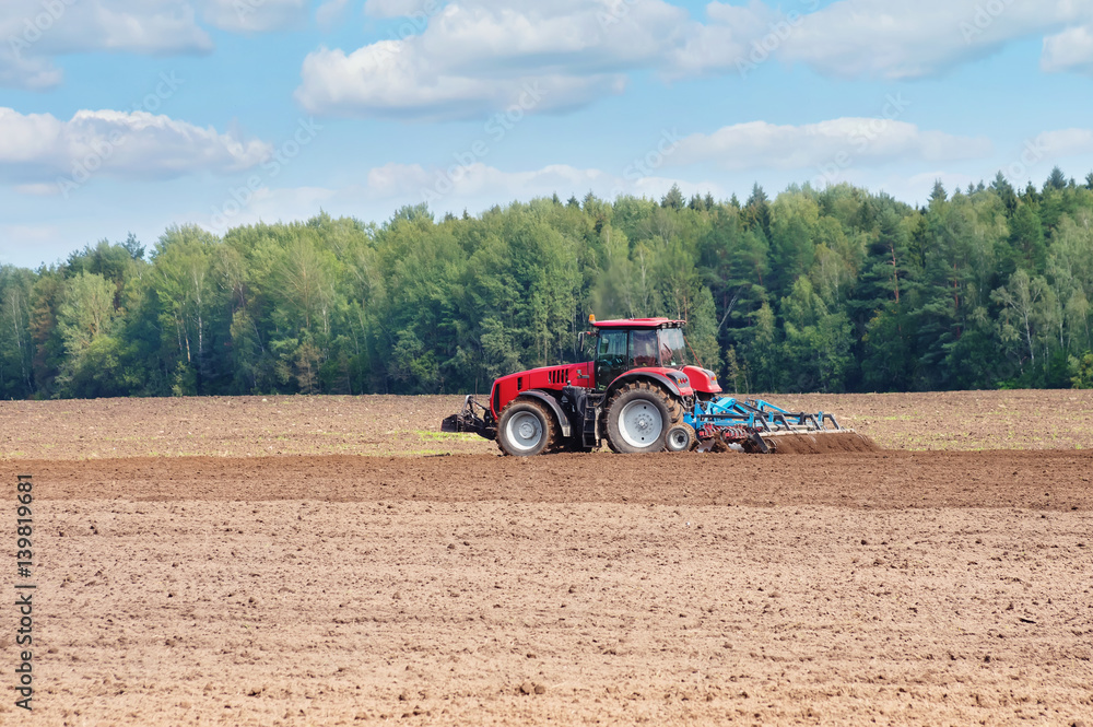 Rural landscape. The tractor in the field cultivates the earth. Rural landscape. The tractor in the field cultivates the earth.