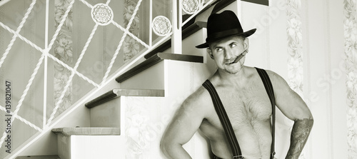 Konstfotografi Muscular macho in a felt hat black and white photo