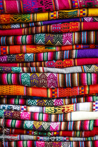 Colorful carpets made of llama and alpaca wool for sale at San Pedro market, Cuzco, Peru.