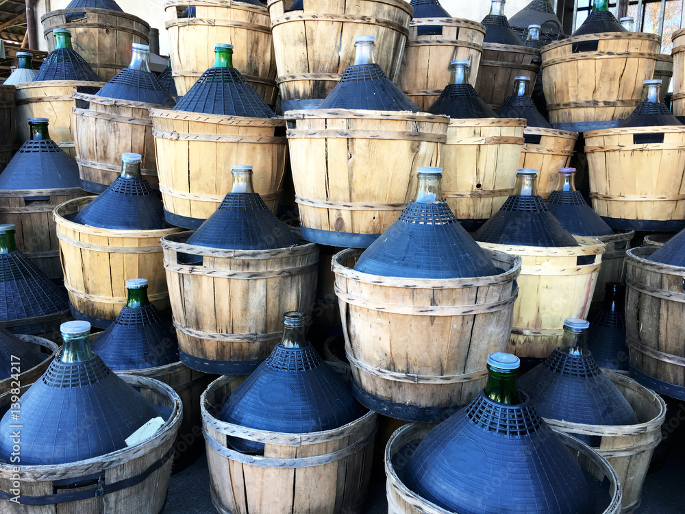 wine carboys bottles enclosed in wickerwork outside at farm wine carboys bottles enclosed in wickerwork outside at farm