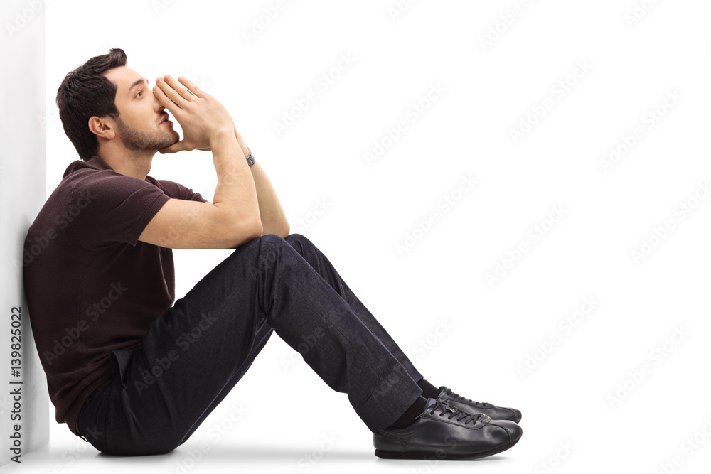 Pensive man leaning against a wall and thinking Pensive man leaning against a wall and thinking