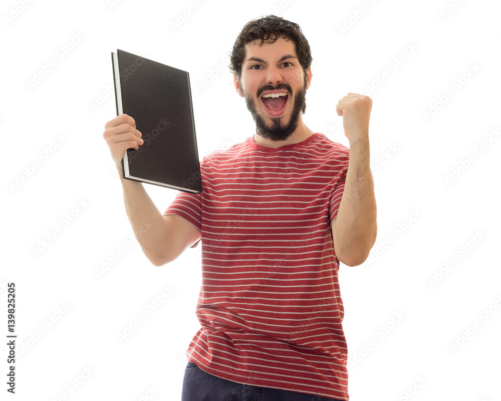 Student celebrates a lot with his notebook in hands. Happy and enthusiastic. Young man with beard, wearing red striped shirt. White background with space for text. Student celebrates a lot with his notebook in hands. Happy and enthusiastic. Young man with beard, wearing red striped shirt. White background with space for text.