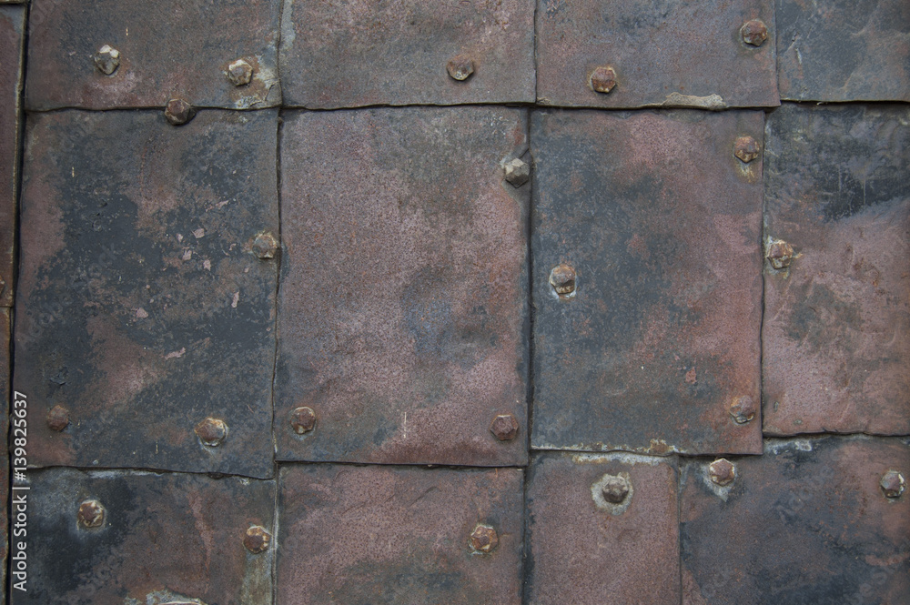Fototapeta premium old rusty metal plates nailed up with wrought tacks