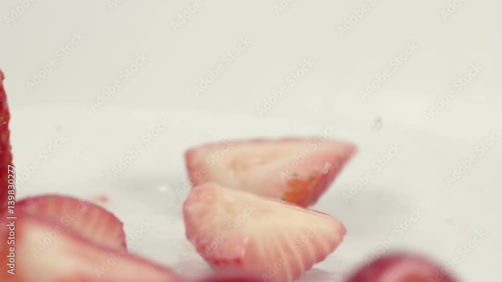 Fresh organic strawberries falling in slow motion Fresh organic strawberries falling in slow motion