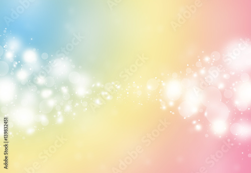 Pastel color sparkles glitter defocused rays lights bokeh abstract holiday background.