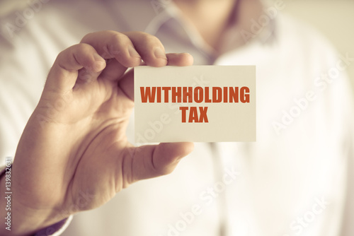 Businessman holding WITHHOLDING TAX message card photo