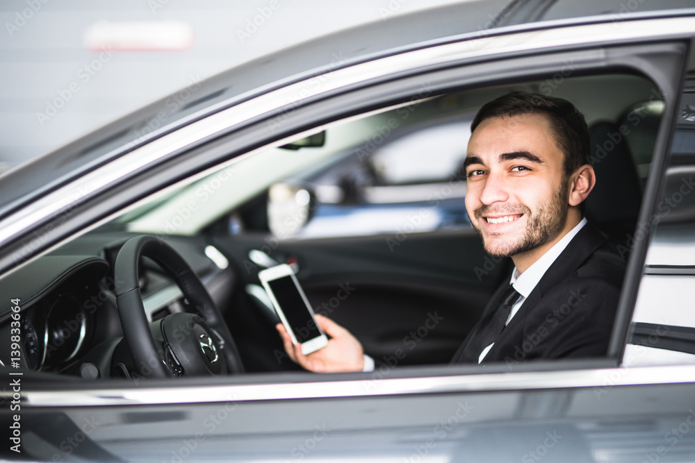 Businessman in car use smartphone and smile on camera Businessman in car use smartphone and smile on camera
