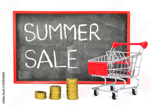 Shopping cart with chalk written word "Summer Sale" on black board