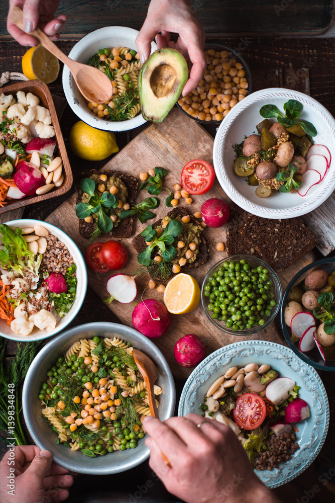 Feast with vegetable salads, fruits and sandwiches Feast with vegetable salads, fruits and sandwiches