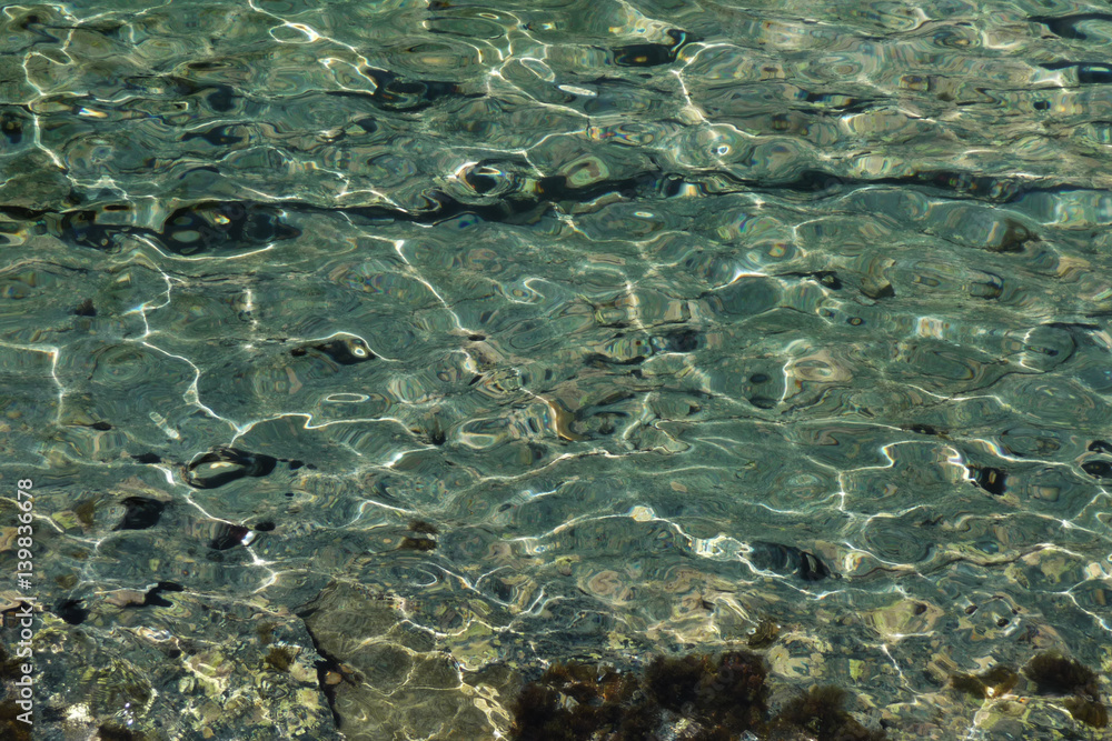 Dazzling pebbles under the waters of Mediterranean sea. Creta, Greece.