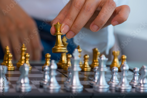 Woman's hand pick up chess pieces