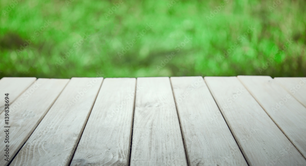 Blank old wooden table in the summer garden on a sunny day (focus on board) Blank old wooden table in the summer garden on a sunny day (focus on board)