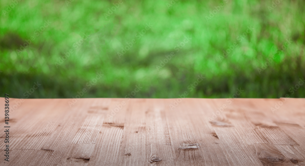 Blank old wooden table in the summer garden on a sunny day (focus on board) Blank old wooden table in the summer garden on a sunny day (focus on board)