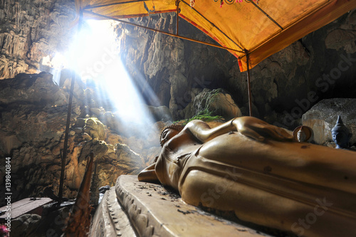 Bronze Thai Buddha in Tham Phu Kham cave photo