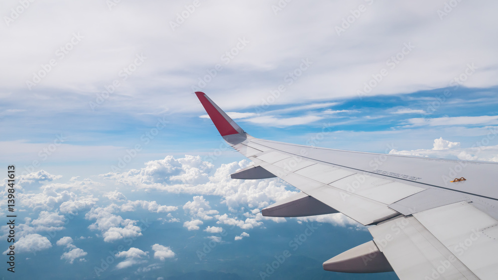 View of airplane window with sky background.