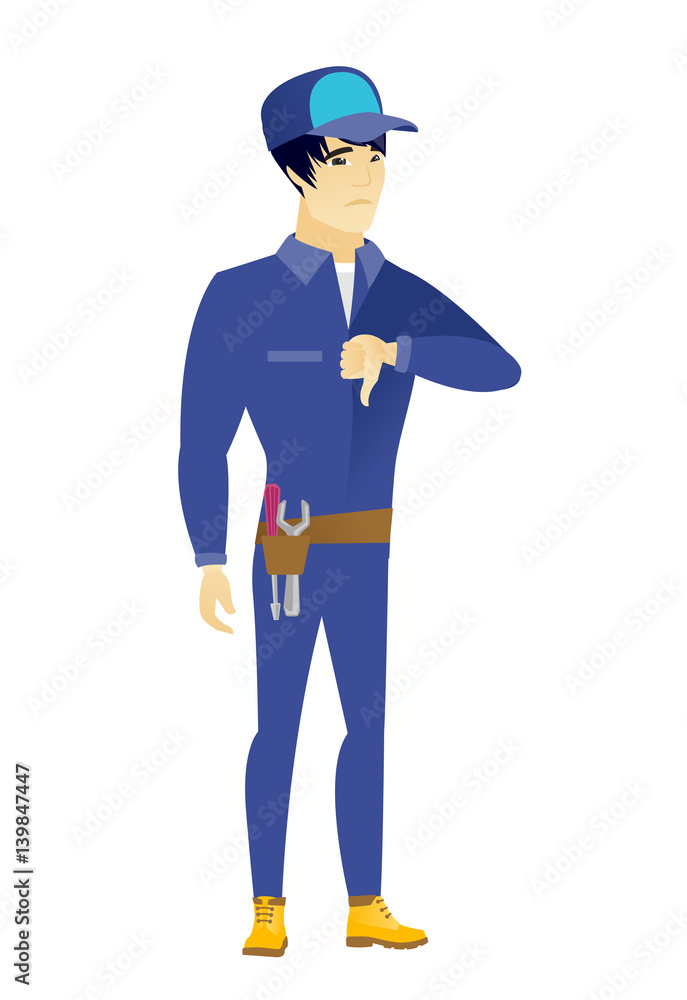 Disappointed asian mechanic with thumb down Disappointed asian mechanic with thumb down