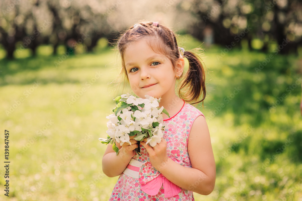 spring portrait of cute smiling child girl with blooming cherries spring portrait of cute smiling child girl with blooming cherries