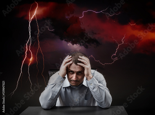 Depressed businessman in a storm