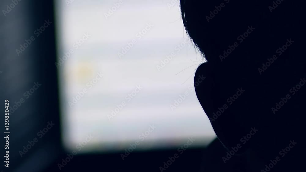 Hacker man working for computer night hacking system offense online Hacker man working for computer night hacking system offense online