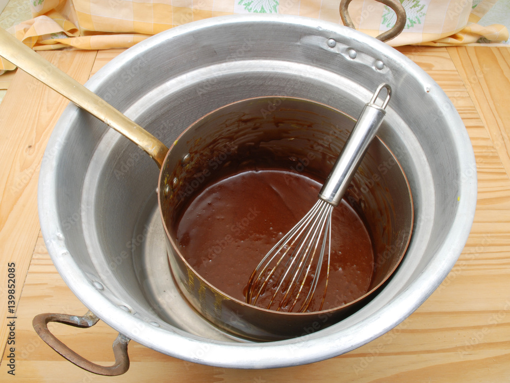 Melted chocolate in a double boiler in copper pot Melted chocolate in a double boiler in copper pot